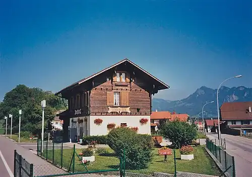 Two-story wooden station building with a station signage