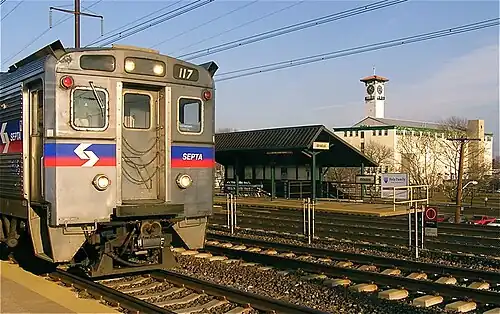 Train at Bristol station with the historic Grundy Mill Complex in the background