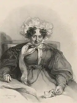 Image of a lady, aged 75, sitting up in her bed