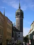 The steeple of All Saints' Church. The inscription Ein' feste Burg ist unser Gott runs just below its base.