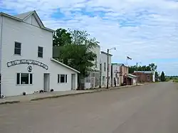 The white storefronts in Kathryn have been preserved close to their historic 1900s state.