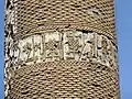 The partially-preserved inscription band near the middle of the tower