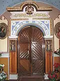 The old entrance to the church, coats of arms of the founders