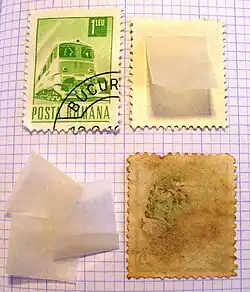 Clockwise from top left: hinge-mounted stamp, stamp about to be hinge-mounted, stamp damaged by a hinge, stamp hinges