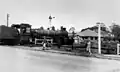 Train passing through the level crossing in Wardell Street, Enoggera ~1950