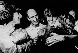 Black-and-white photo of Stayner's family members rushing to greet him