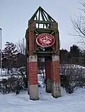 An entrance sign for the mall along Sheep Davis Road (New Hampshire Route 106) on December 5, 2025, featuring the mall's first logo.