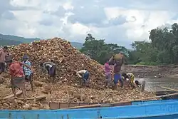 Workers collecting stones from Shah Arefin Tila