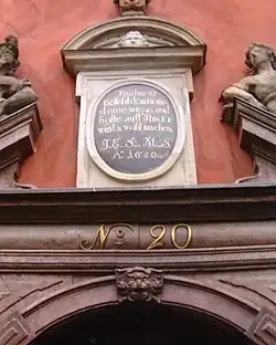 Inscription over the front door of 20 quoting Psalm 37:5 in German: "Befiehl dem Herrn deine Wege und hoffe auf ihn, er wirds wohl machen". English translation: "Commit thy way unto the Lord; trust also in Him, and He will bring it to pass."