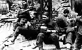 SS soldiers pause to eat during the suppression of the Warsaw ghetto uprising