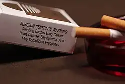 Label on a cigarette carton, reading SURGEON GENERAL'S WARNING: Smoking Causes Lung Cancer, Heart Disease, Emphysema, And May Complicate Pregnancy.