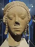 Vestige of a statue: a woman's head.