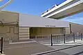 Pedestrian entrance to Terminal B, with Skylink overpass in background