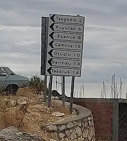 A road sign showing distances and direction to Taşgedik and other villages