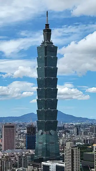 Photo of Taipei 101 tower against a blue sky.