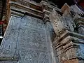 Stone images featuring flora and mythical creature motifs in relief, similar in craftsmanship to those found in Bagan.