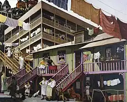 Tenements with women drying laundry on clothes lines