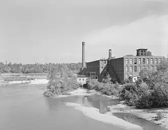 black and white photo of textile mill along river in Winooski, Vermont