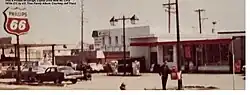 Exterior view of a 1970s-era gas station with Phillips 66 signage and several cars parked in front.