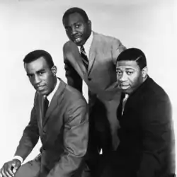 The three musicians wearing suits