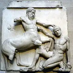 Block of ancient Greek sculpture, in high relief, showing a centaur fighting a man