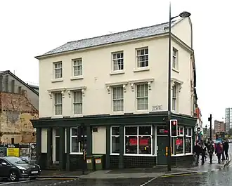 3-storey building, black on ground floor, white on first and second floor
