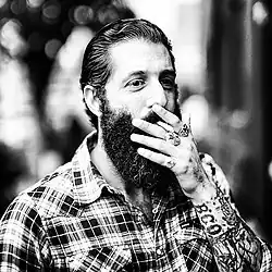 Image 24A man with sleeve tattoos, beard and flannel shirt, mid 2010s (from 2010s in fashion)