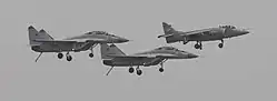 A Sea Harrier flanked by a pair of MiG-29Ks during the retirement of the Sea Harrier.