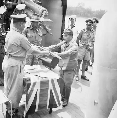 The official surrender ceremony of the Japanese to the Australian forces on board HMAS Kapunda at Kuching, Kingdom of Sarawak, on 11 September 1945