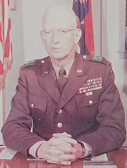 1956 color photo of Major General Thomas M. Watlington seated at desk