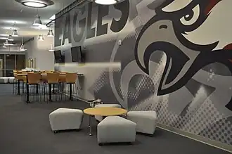 Interior space with clusters of seating and an eagle print on the wall