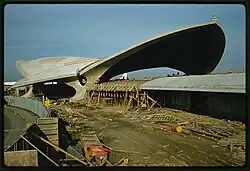 The building under construction. Only the concrete roof has been poured; the glass has not been installed yet.