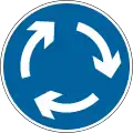 Mini-roundabout; vehicles must give way to traffic from the right and pass to the left of the central markings unless physically unable to do so