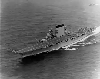 The aircraft carrier USS Lexington steaming ahead leaving behind a prominent wake