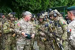 U.S. Army Gen. Bryan Fenton, commander of U.S. Special Operations Command shows his Green Beret selection number to Portuguese Army Rangers