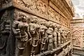 Intricate stone carvings of female figures on the exterior of the Uma Maheshswara shrine at the Bhoga Nandeeshwara Temple complex