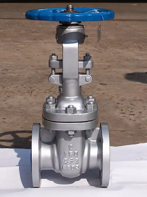 A 2″ stainless steel gate valve with flanged ends. Bolts connect the lower valve body with the upper “bonnet”. Visible threads on the valve stem protruding above the handwheel show that this is a rising-stem valve.