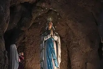 La Venerada y Coronada Imagen with Saint Bernadette Soubirous, enshrined above the high altar