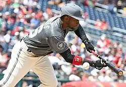 Victor Robles bunting in a gray Washington Nationals jersey in 2022