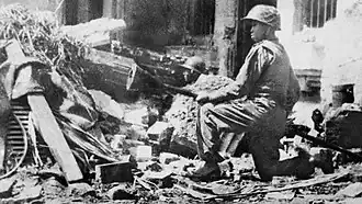 Viet Minh soldier Nguyen Van Thieng holding a lunge mine at Hàng Đậu Street in December 1946.