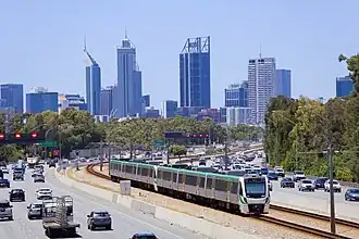 A freeway with a railway in the median strip