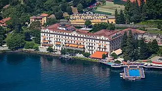 View of a large lakeside villa complex with extensive gardens