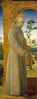 Painting of a full-length man dressed as a monk with a halo on his head.