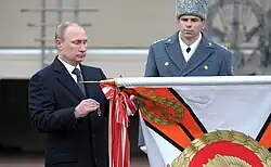 Vladimir Putin with the banner of the school.