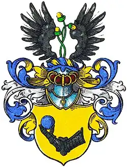 An illustrated coat of arms with an armoured arm.