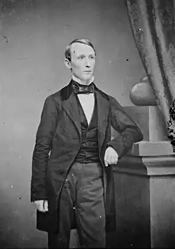 A black-and-white photograph of William Walker wearing mid 18th century formal attire