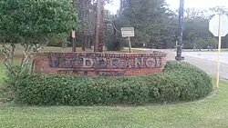 Welcome sign at the entrance to Woodbranch Village