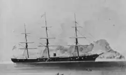 A black-and-white photo of a three-masted ship with one funnel