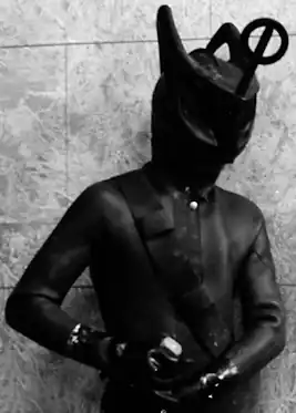 An alien creature in a rubber wetsuit
