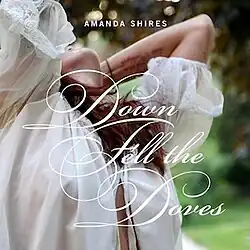 photo of Amanda Shires wearing a gauzy white top leaning far back and looking up to the sky with her hands in her hair